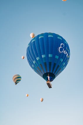 A group of enthusiastic students launching a research balloon into the clear stratospheric sky.