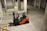 An electric forklift operating smoothly in a bright warehouse with green accents.