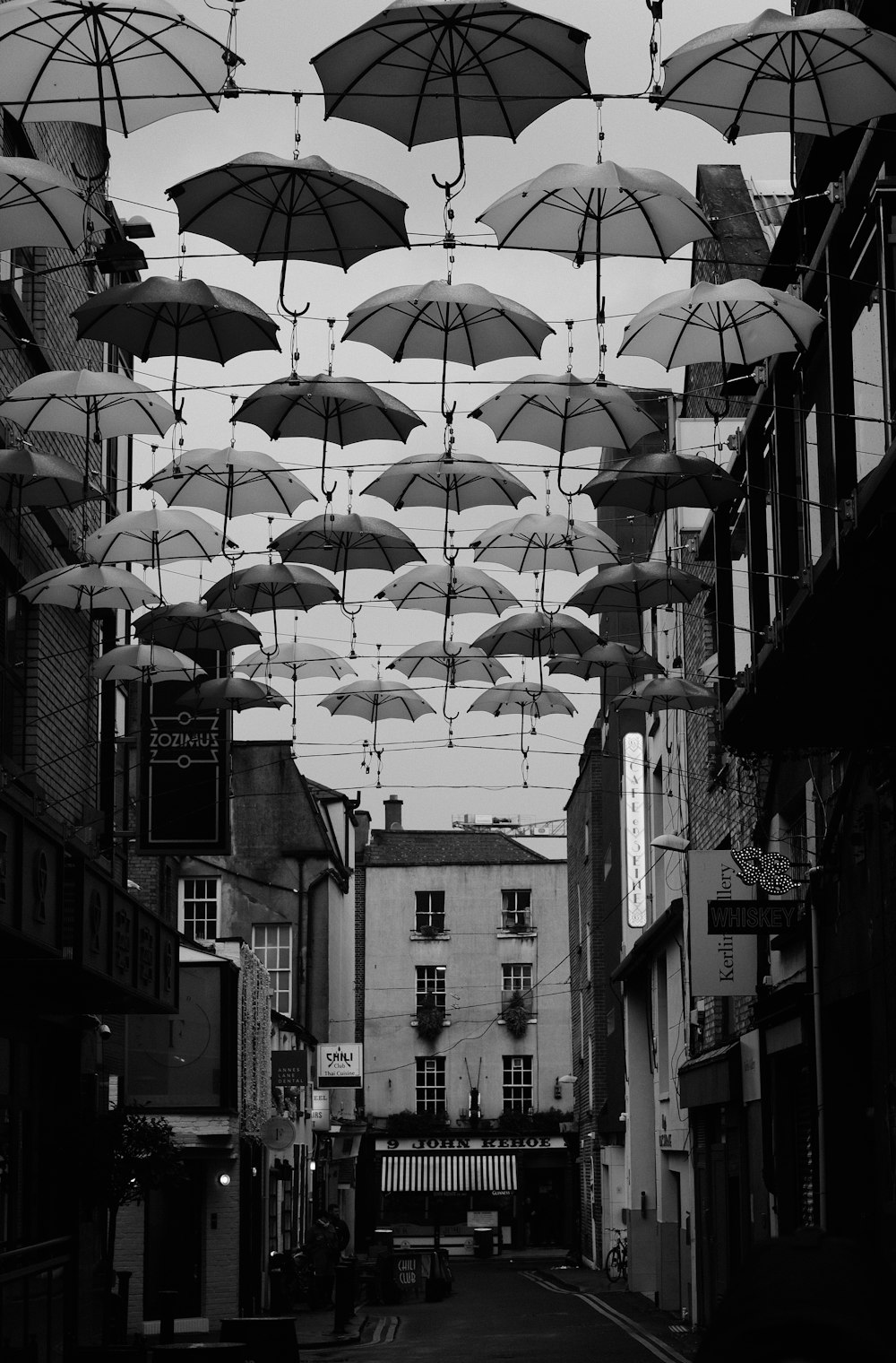 a bunch of umbrellas that are hanging in the air