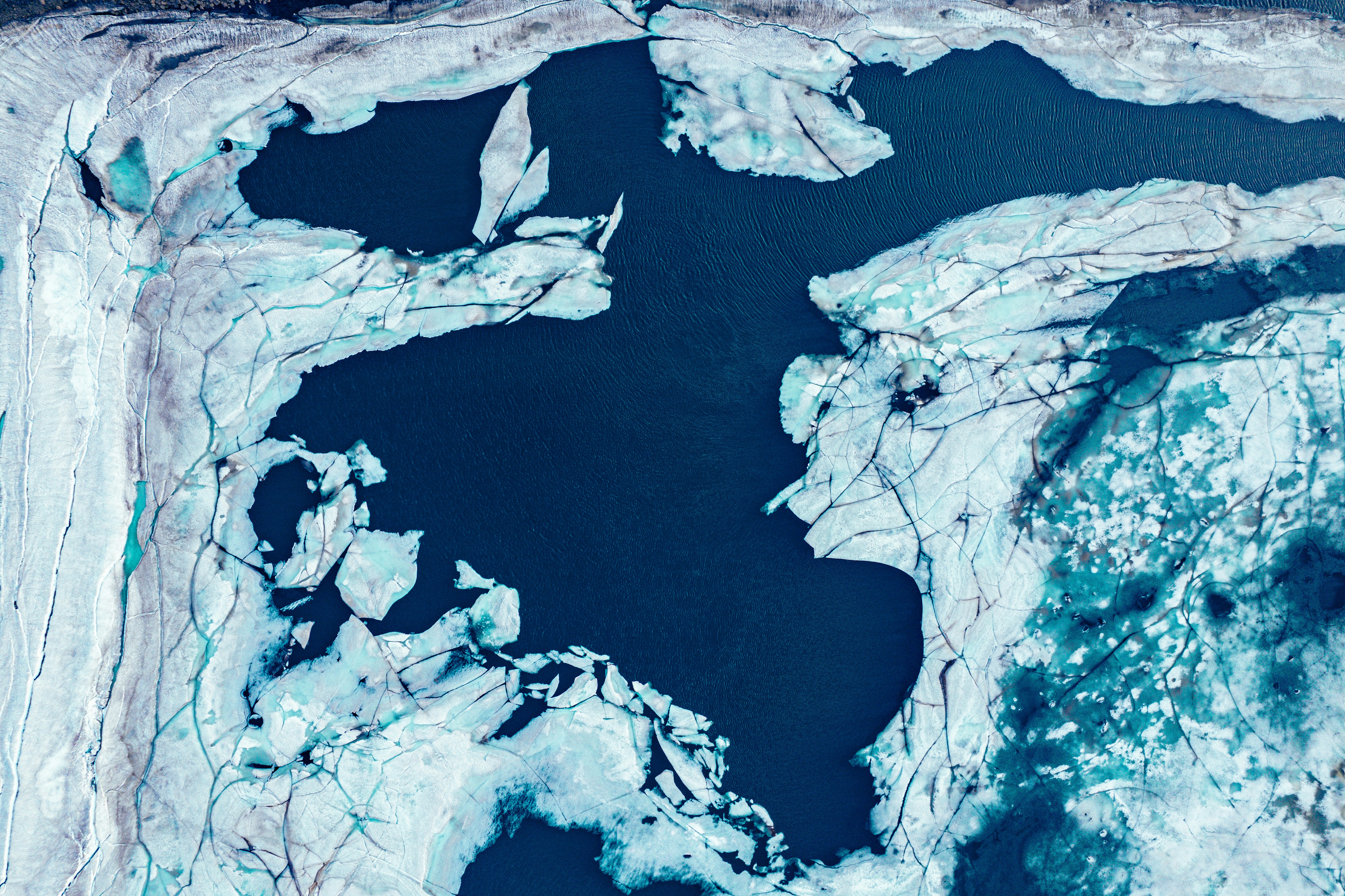 an aerial view of a glacier and a body of water