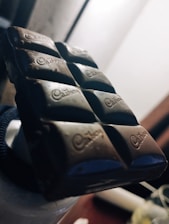 Close-up of rich, glossy chocolate bars being crafted in a factory setting.