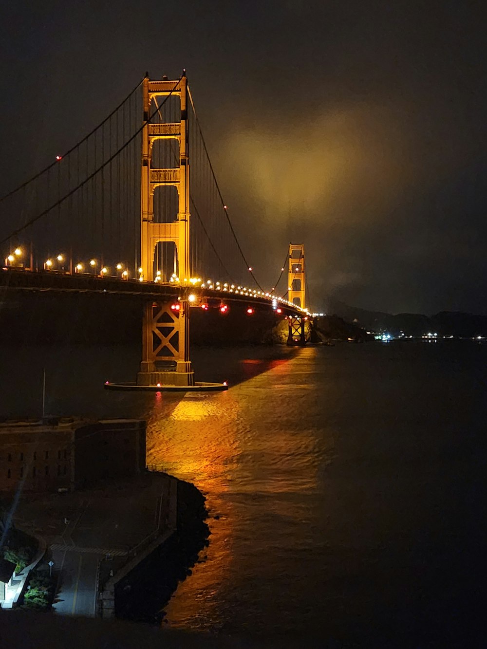 the golden gate bridge is lit up at night