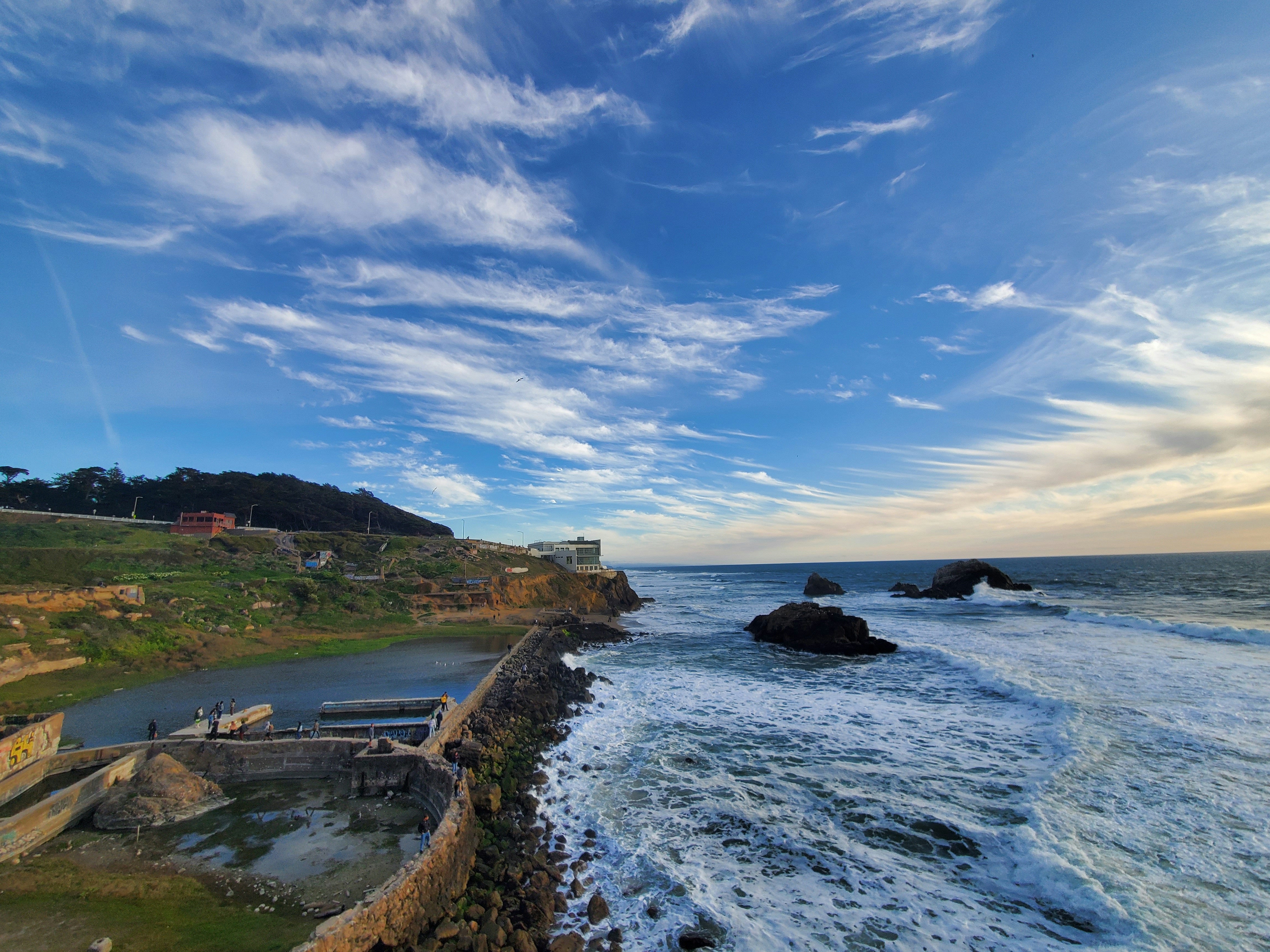 a view of the ocean from a cliff, Sutro Baths, a historic attraction in San Francisco, were originally built in 1896 by entrepreneur Adolph Sutro and comprised the world