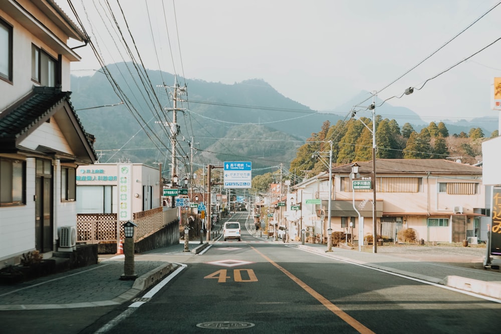 an empty street with a mountain in the background