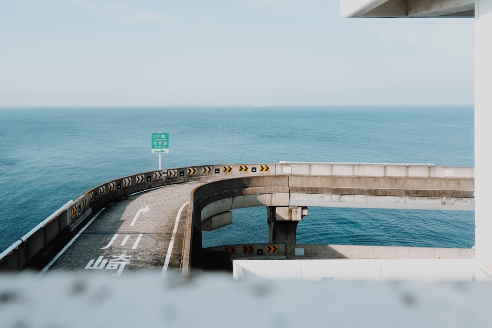 a view of the ocean from the top of a bridge