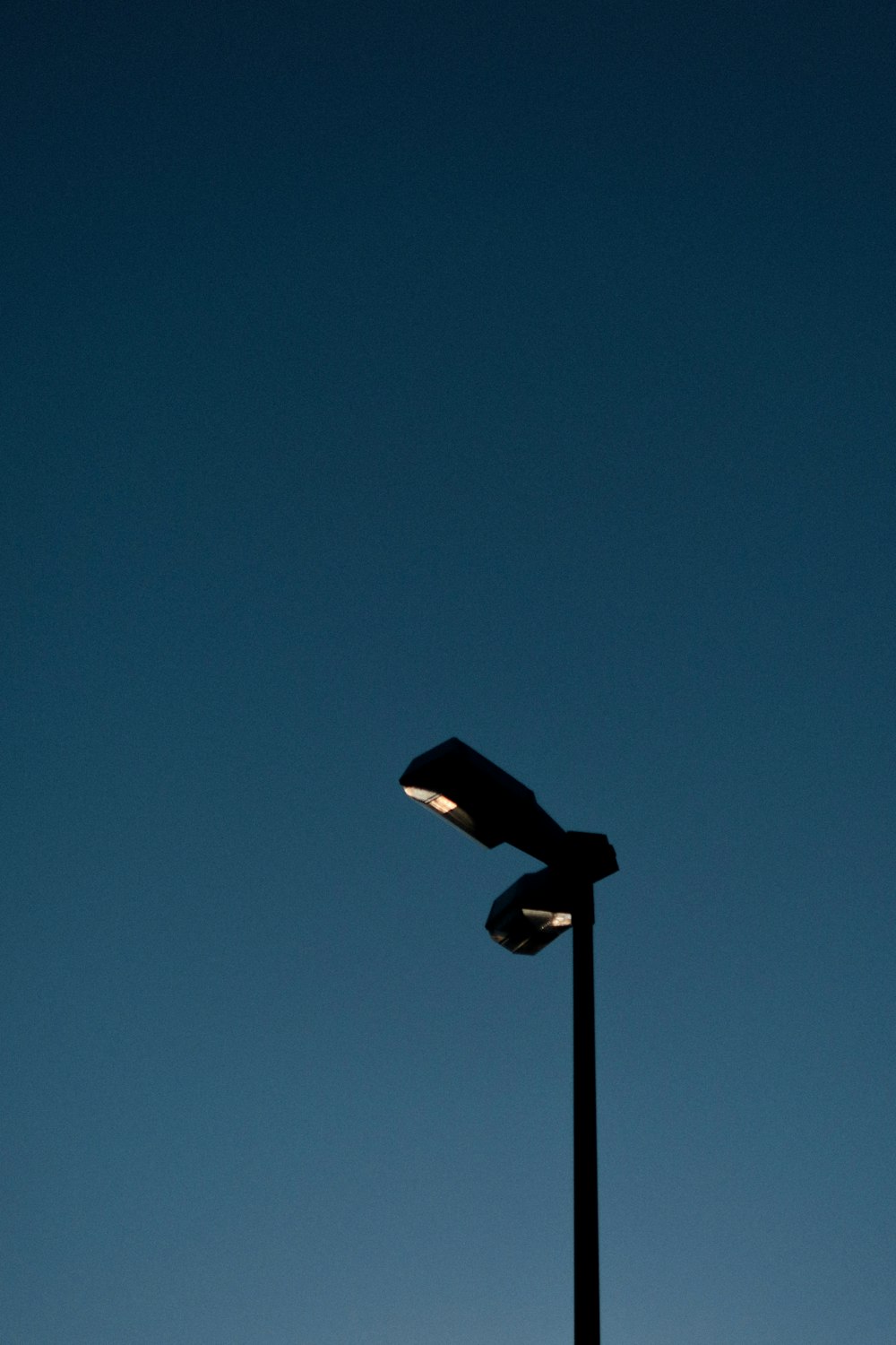 a street light with a blue sky in the background