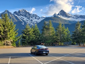 A modern economy car parked in a scenic location.