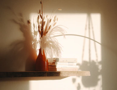 a couple of vases sitting on top of a shelf