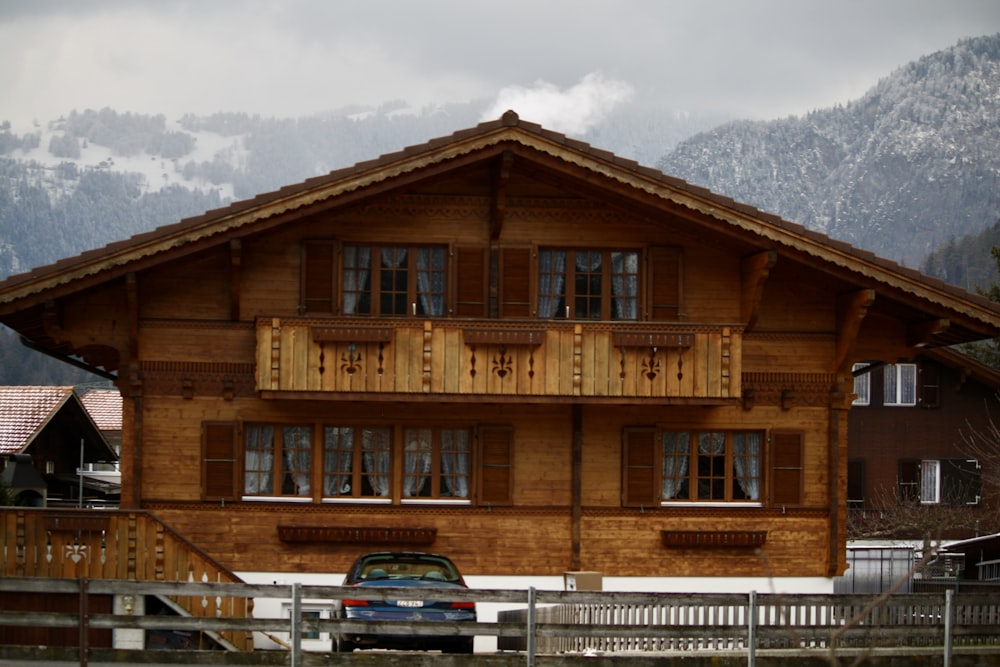 a car parked in front of a wooden house