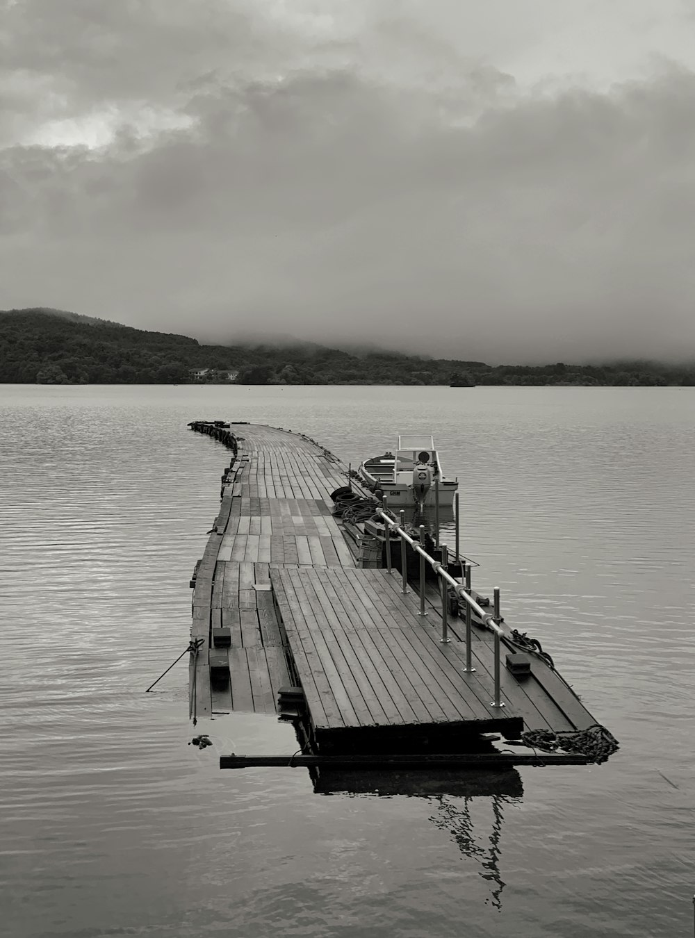 a long dock sitting on top of a large body of water