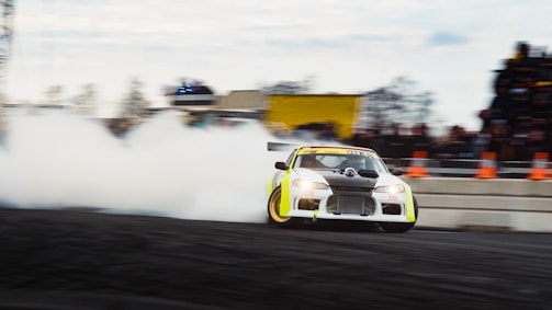 A thrilling moment of a race car drifting sharply around a corner.