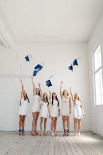 A diverse group of students celebrating their acceptance letters in a bright, modern office.