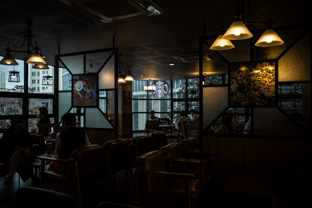 a dimly lit restaurant with people sitting at tables