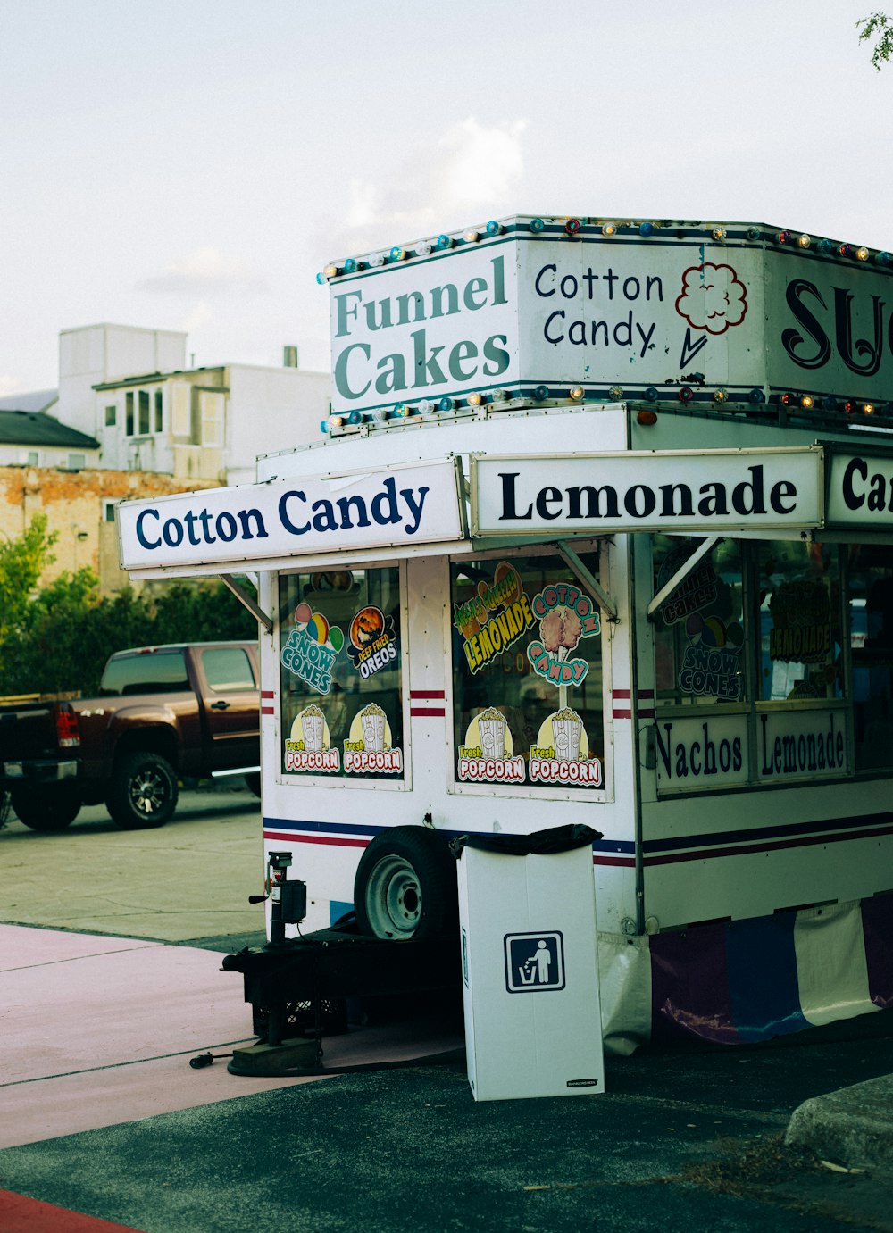 a street vendor selling lemonade and cotton cakes