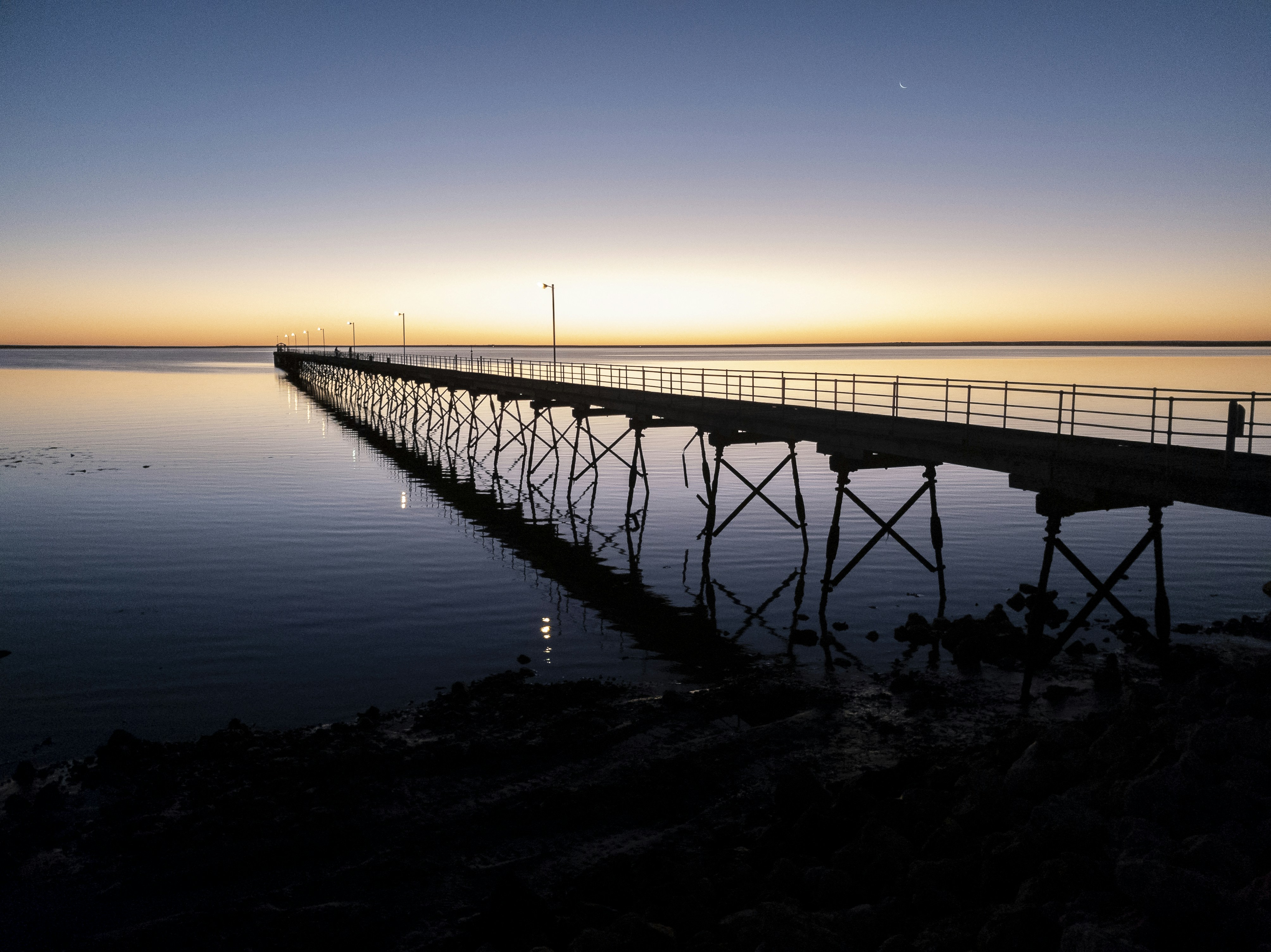 a long pier sitting on top of a large body of water