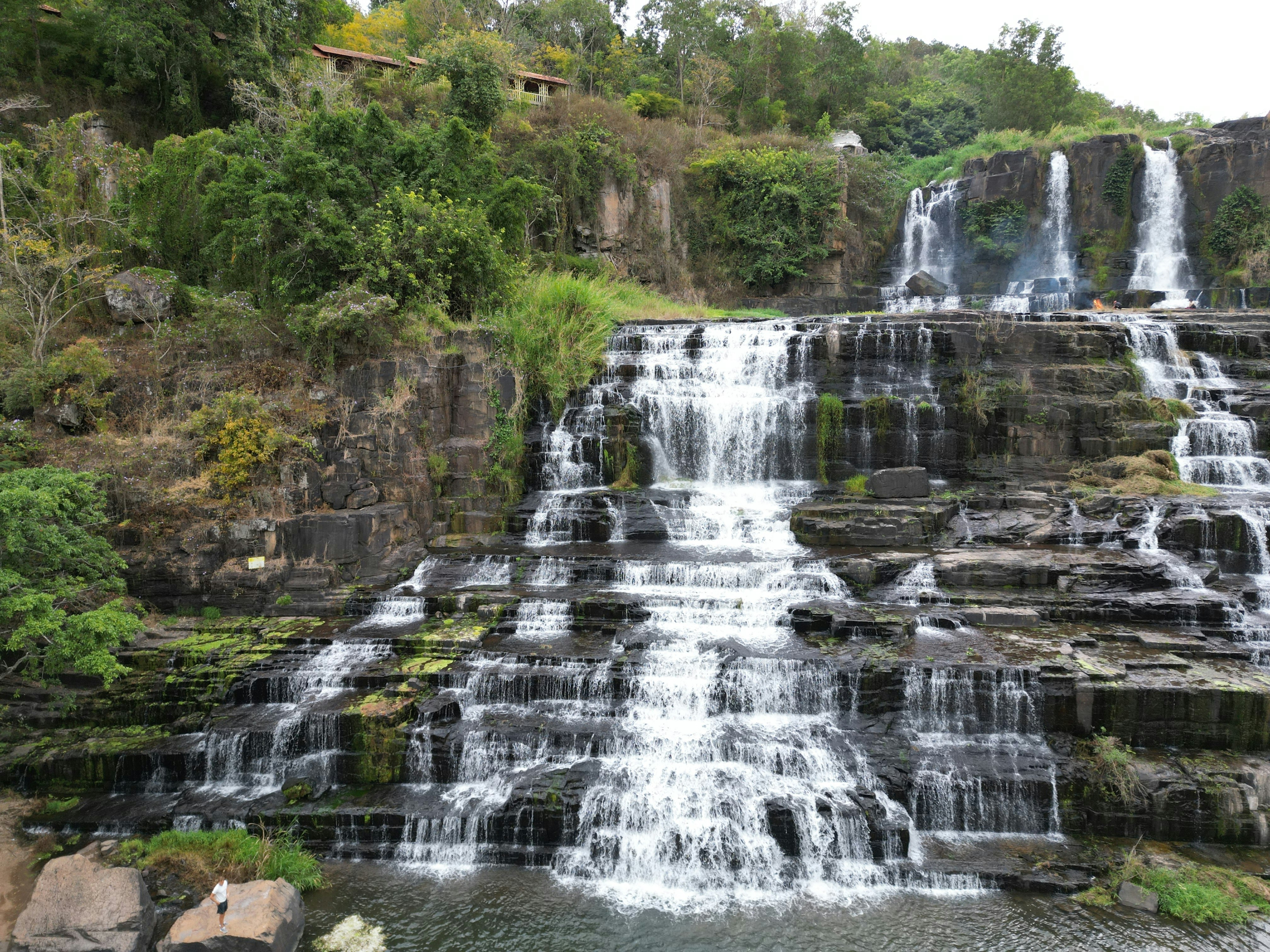 a large waterfall with lots of water coming out of it, 
