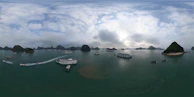 A panoramic view of the Ría de Vigo with boats sailing under a clear blue sky.