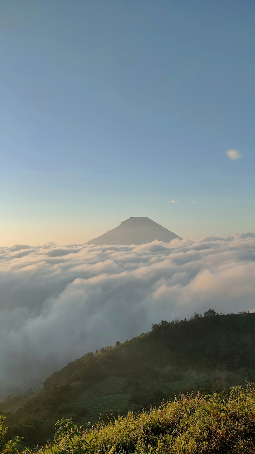 a view of a mountain covered in clouds