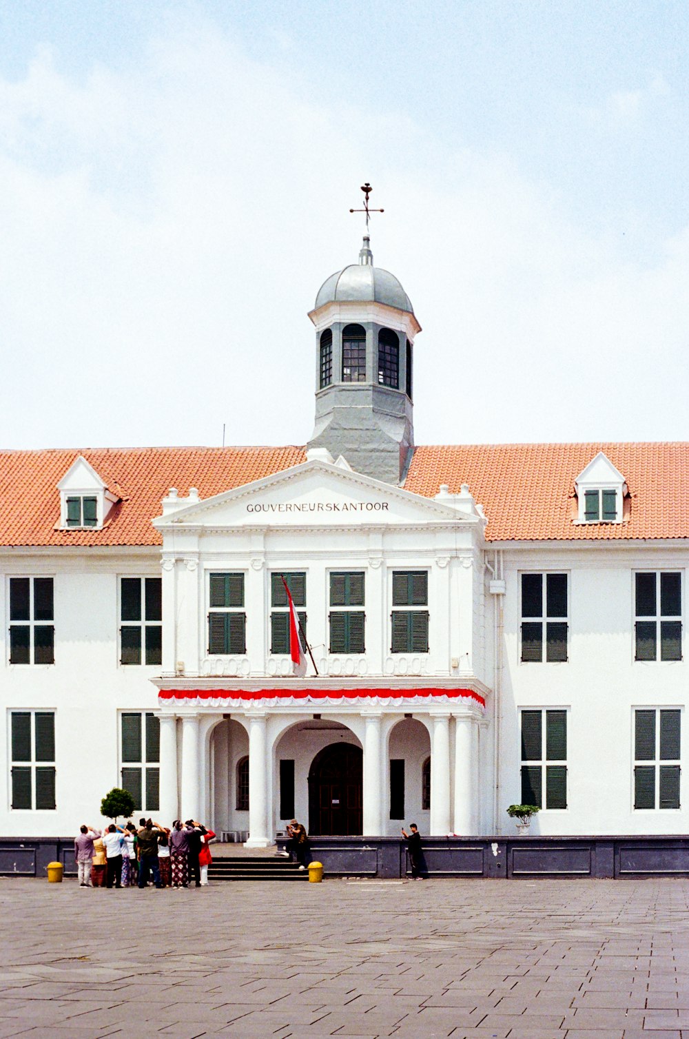 a large white building with a clock tower