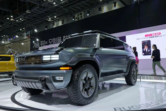 A sleek SUV displayed with detailed specs and pricing on a digital tablet.