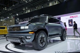 A professional sales advisor dressed smartly, engaging warmly with a customer beside a modern SUV.