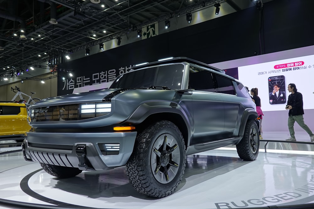 a gray suv is on display at a car show