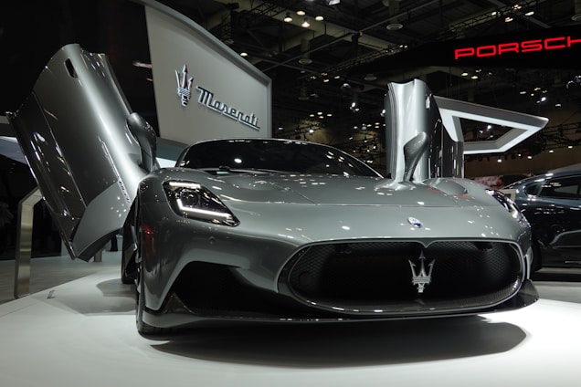a silver sports car is on display at a car show