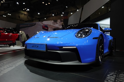 a blue sports car on display at a car show