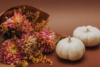 A vibrant bouquet of freshly picked autumn flowers arranged with delicate petals in warm hues.