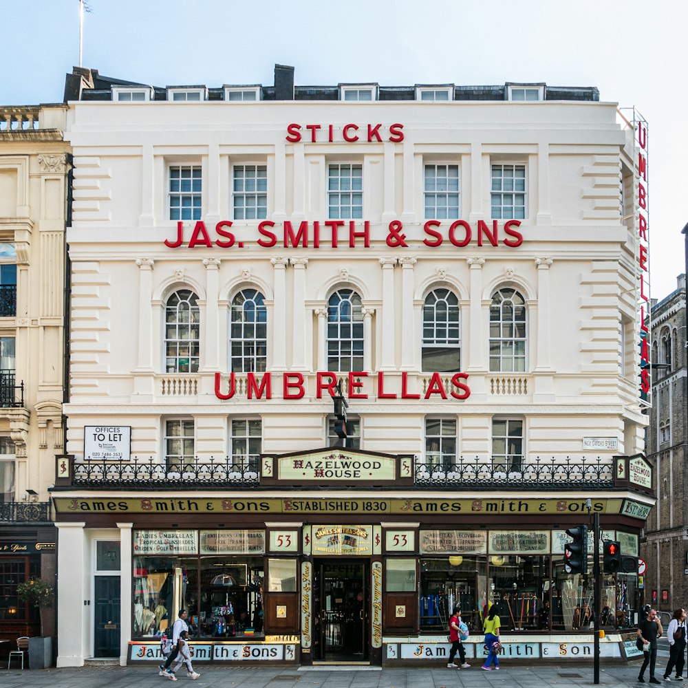 a large white building with a sign that says jas smith & sons umbrellas