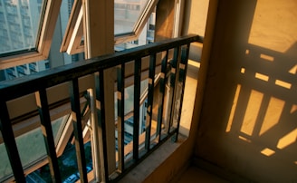 Image capturing sunlight filtering through the pigeon net on a residential balcony.