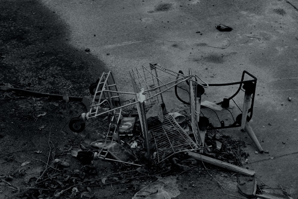 a black and white photo of a broken shopping cart