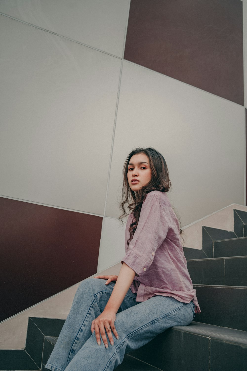 a woman sitting on the steps of a building