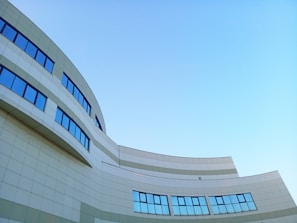 A newly completed administrative building with modern glass facades under a clear sky.