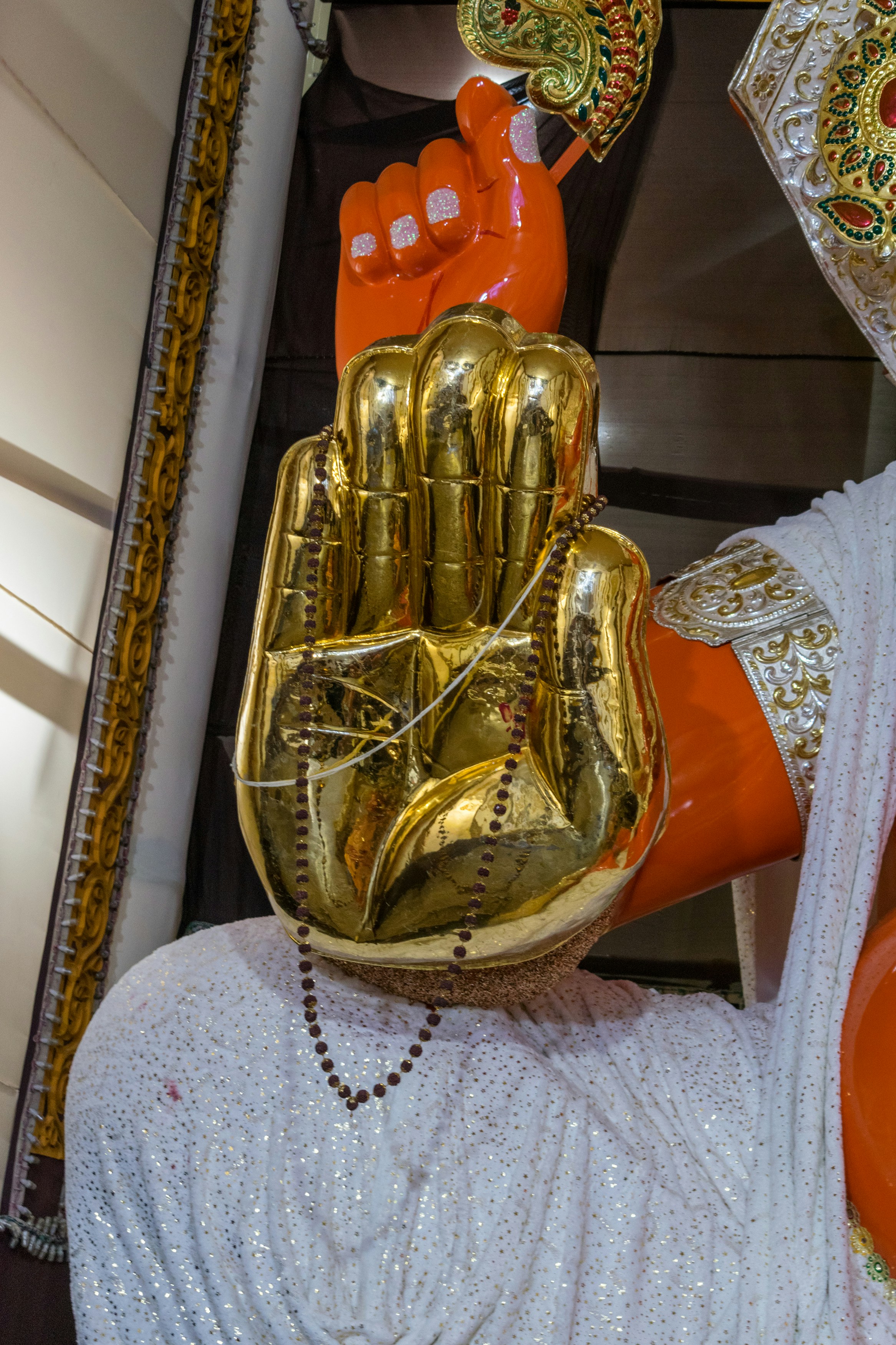 a statue of a person wearing a gold glove