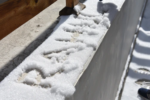 A freshly cleaned driveway shining under the morning sun, showcasing pristine concrete after pressure washing.
