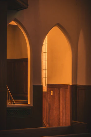 Soft natural light illuminating a serene memorial space with subtle golden accents.