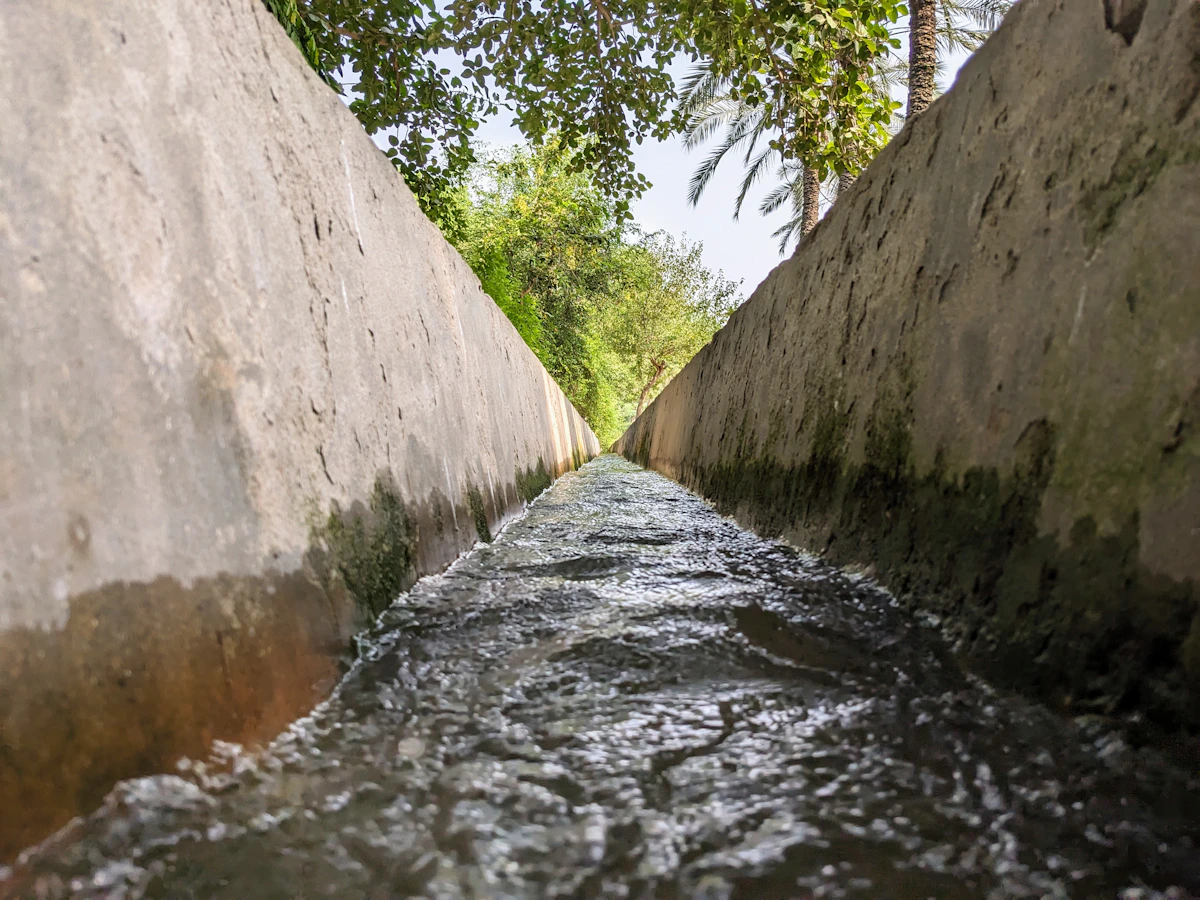 Clear water moving over rocks in a stream, illustrating the cool, gentle flow most suited to rinsing the water-safe stones described below
