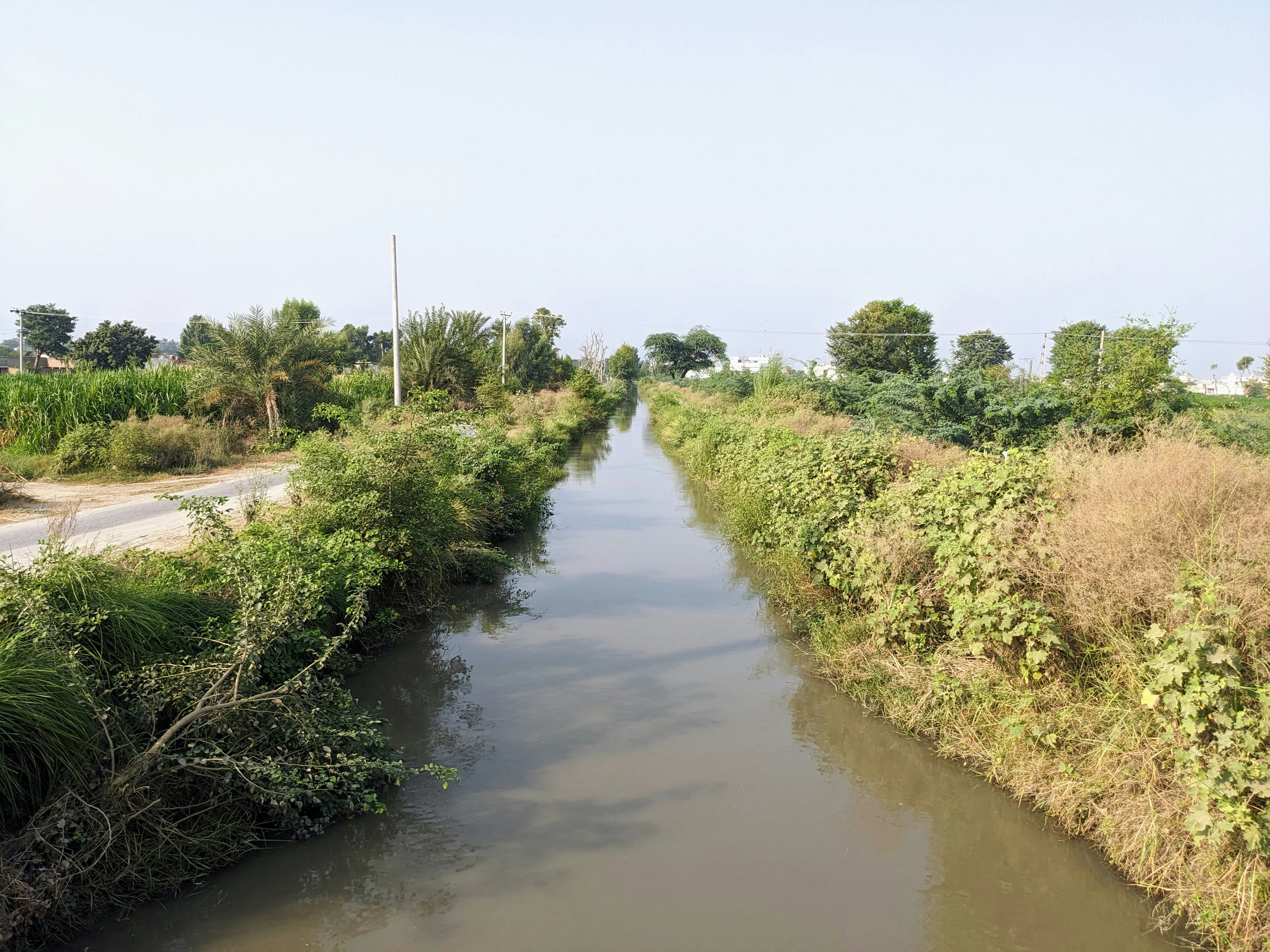 a river running through a lush green countryside
