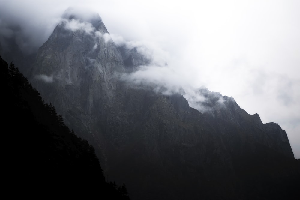 a very tall mountain covered in clouds and fog