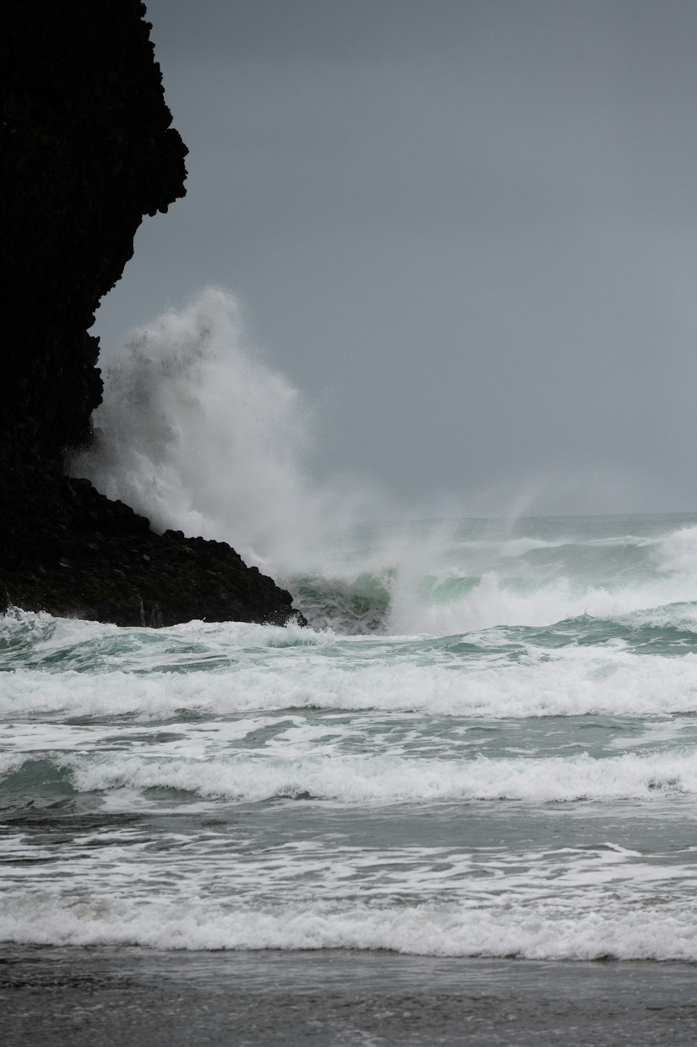 a person standing in the ocean with a surfboard