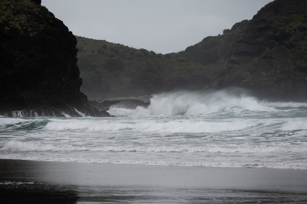 a large body of water near a rocky shore