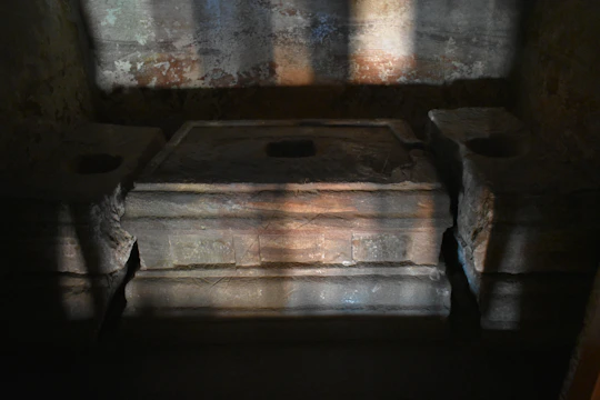A dimly lit altar with candles flickering around ancient runes.