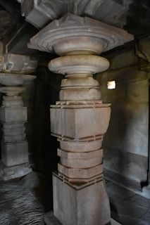 A detailed close-up of an ancient symbol carved in stone, glowing softly in warm light.