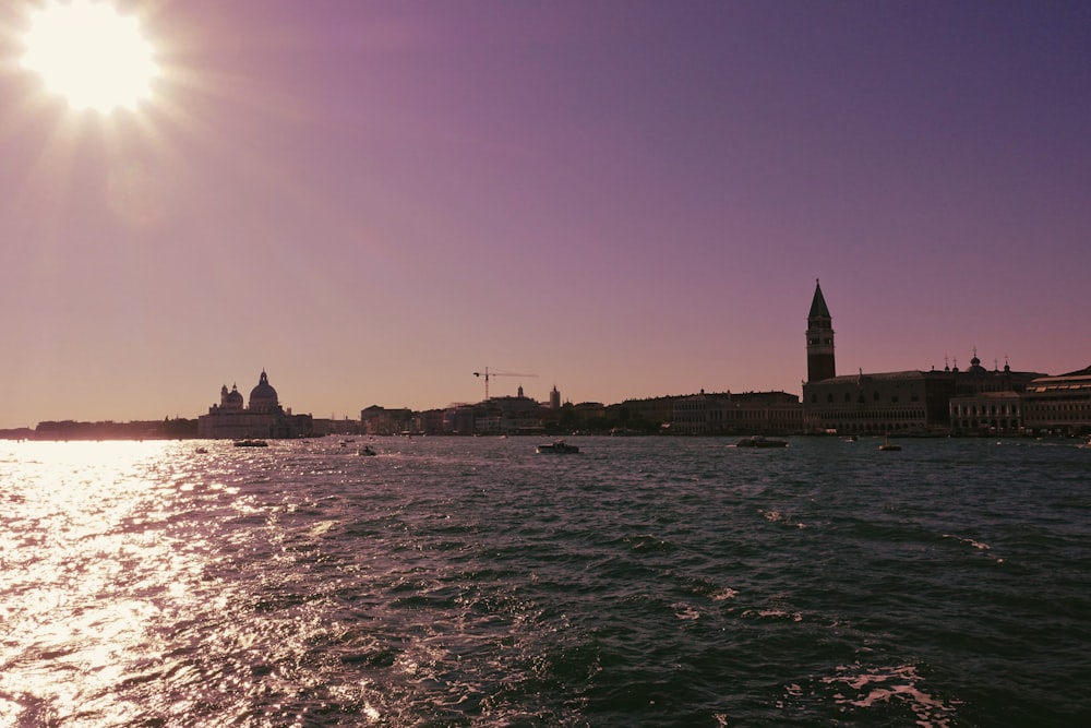 a large body of water with a clock tower in the background