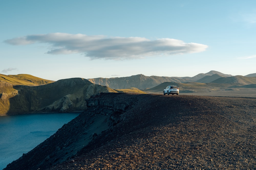 a van is parked on the side of a mountain