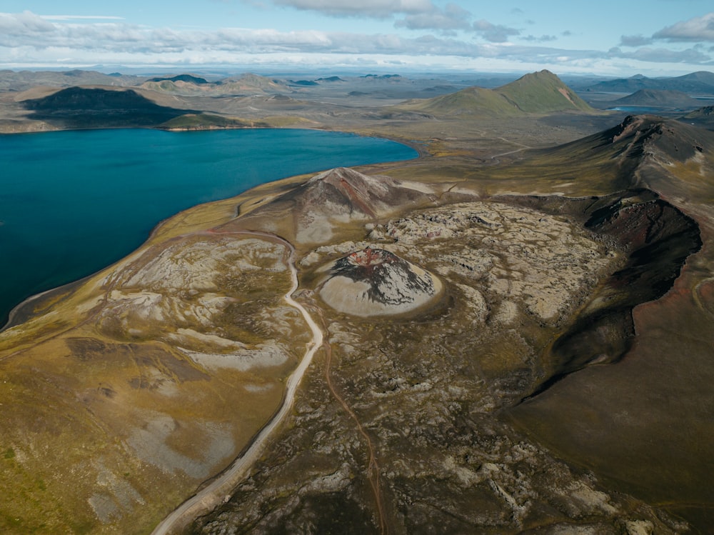 an aerial view of a lake surrounded by mountains