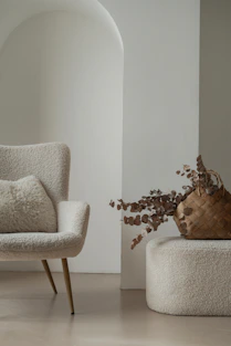 a chair and a vase with a plant in it