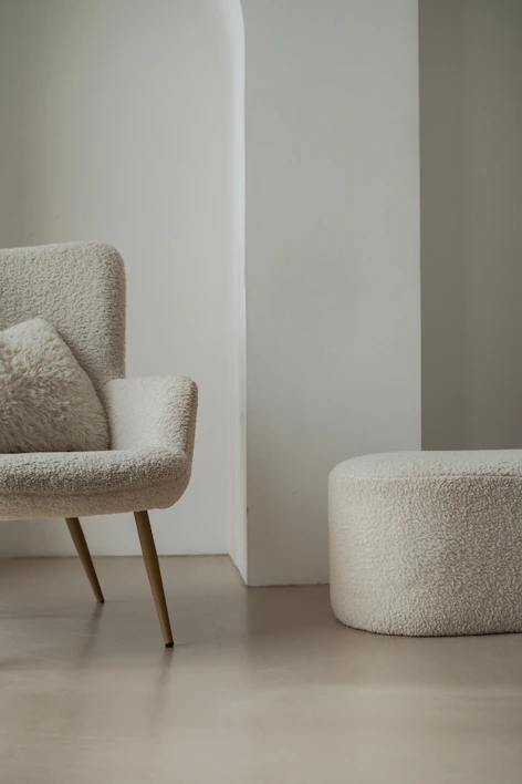 A clear acrylic lift ottoman showcasing its sleek, modern design in a cozy living room.