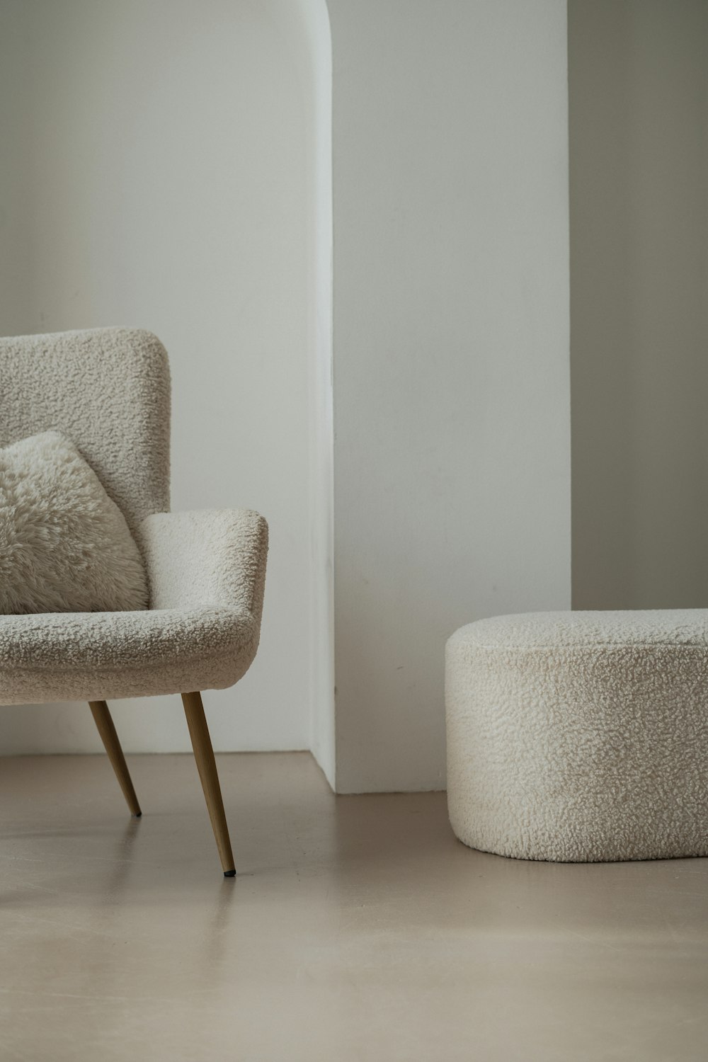 a white chair and ottoman in a room